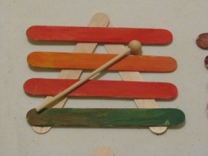 Making craft stick xylophones in preschool