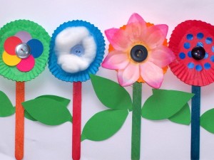 flower cupcake mold cups, buttons, and popsicle sticks.